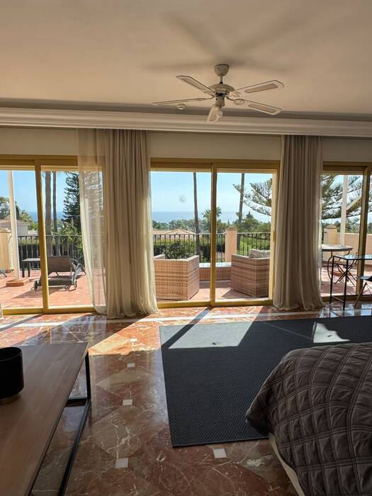 Private suite at InHarmoni with sliding glass doors to a balcony and sea view